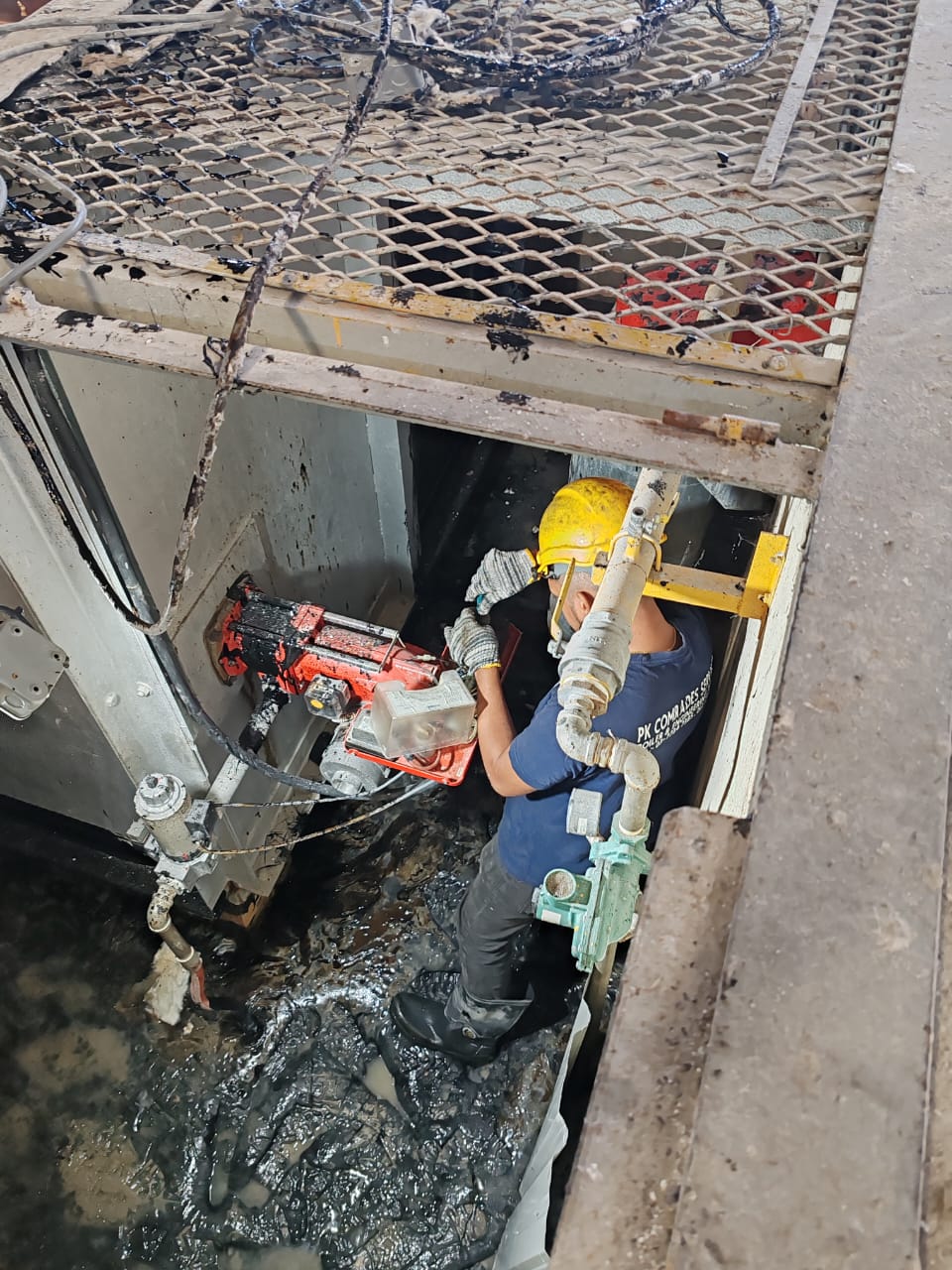 Technician calibrating industrial burner combustion in Malaysia