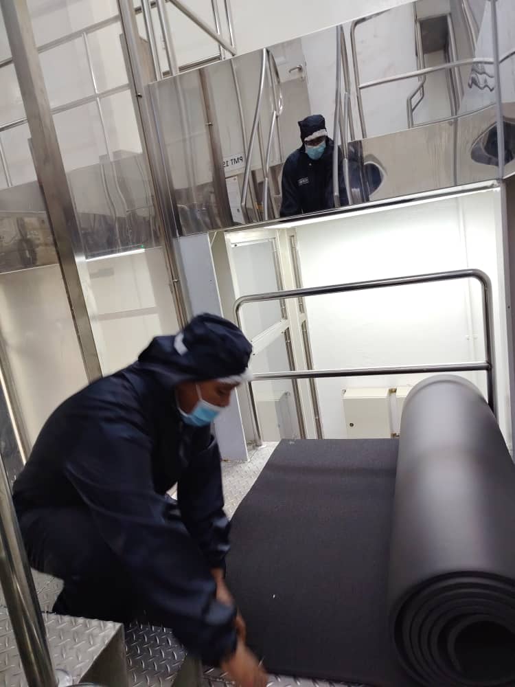 Technician performing hot and cold pipe thermal insulation in Malaysia